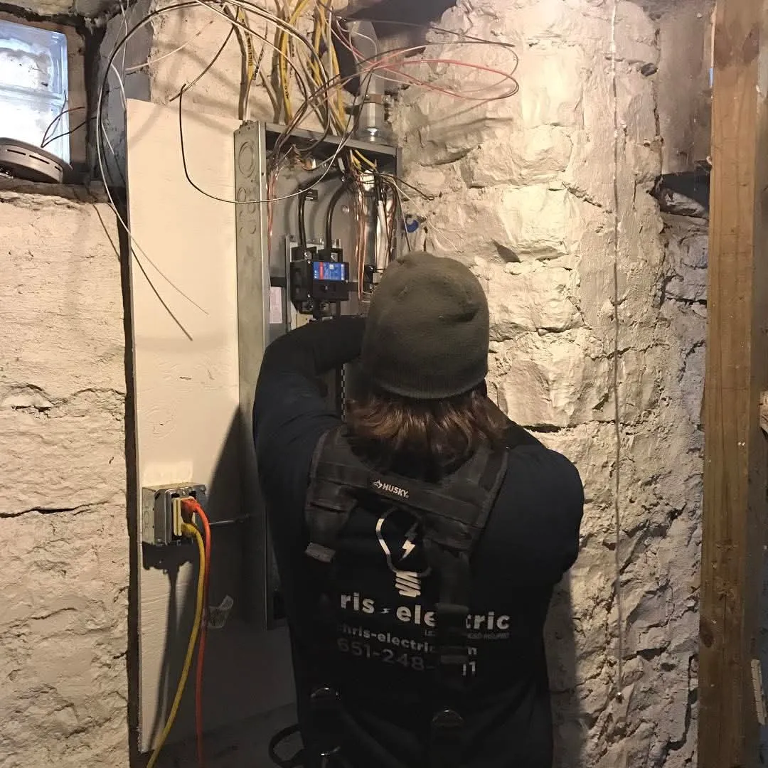 Electric repairman in White Bear Lake, MN working on a basement electrical panel