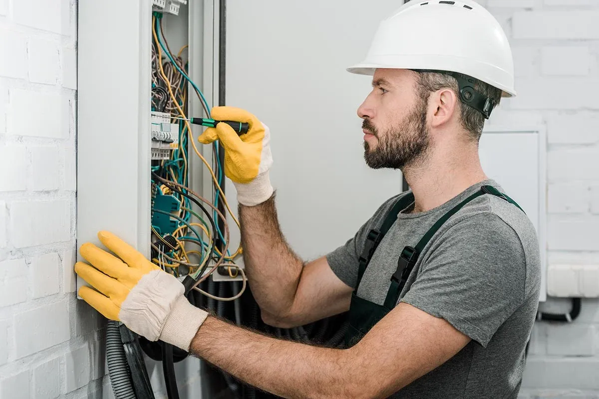 Licensed electrician serving White Bear Township, MN, working on wiring inside an electrical panel