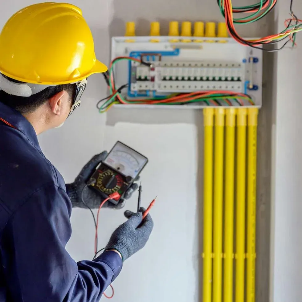Chris Electric electrician checking a new breaker panel with a meter before the power goes back on